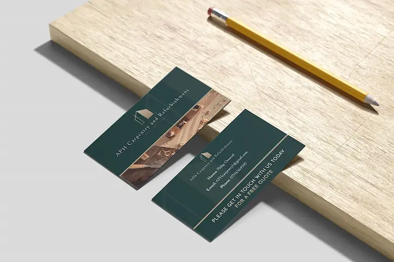 Business card design for APH Carpentry in Yeovil, Somerset, displayed on a wooden surface alongside a pencil.