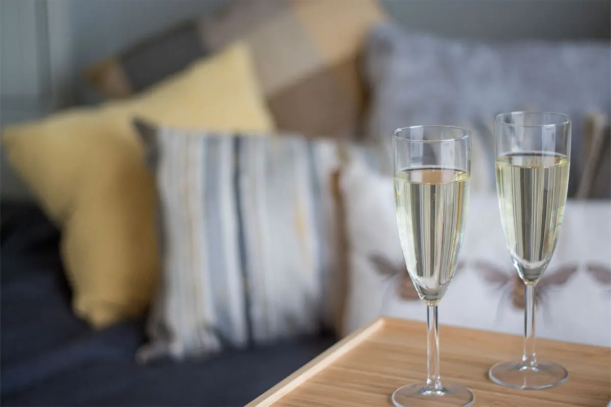 Champagne glasses on a table in a shepherds hut