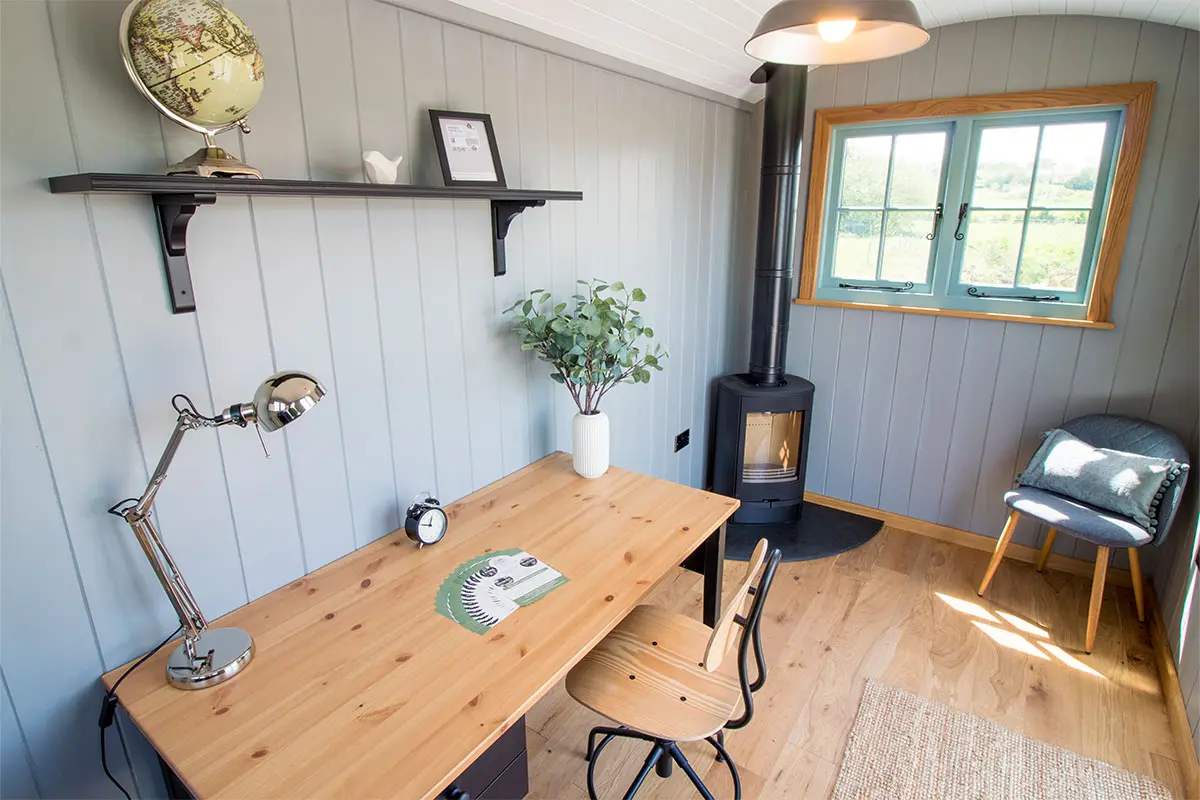 Shepherds hut office with a desk and stove