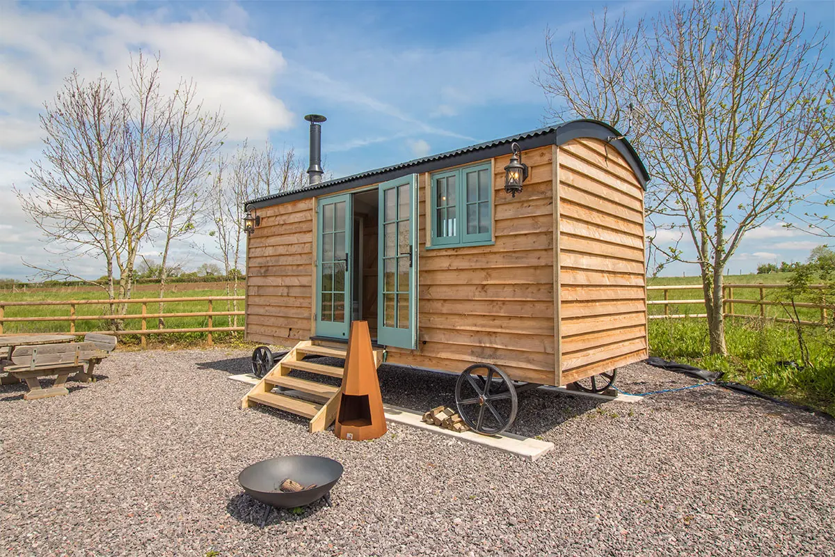 Outside photo of a shepherds hut with wooden cladding