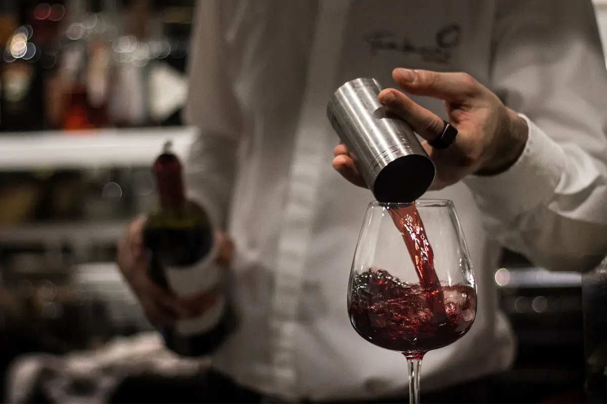 Red wine being poured into a wine glass at Tamburinos Yeovil