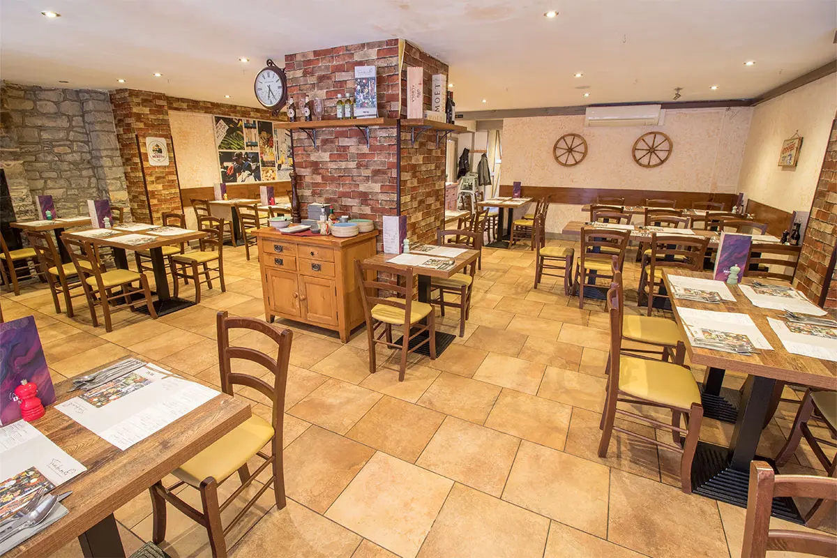 Inside of the Tamburinos Street Restaurant with tables and chairs