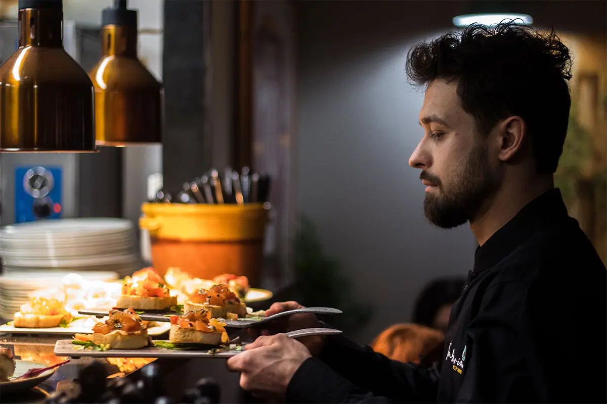 Tamburinos Yeovil waiter holding 2 plates of food