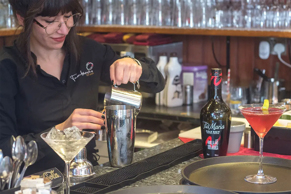 Tamburinos waiter pouring a coffee at the bar