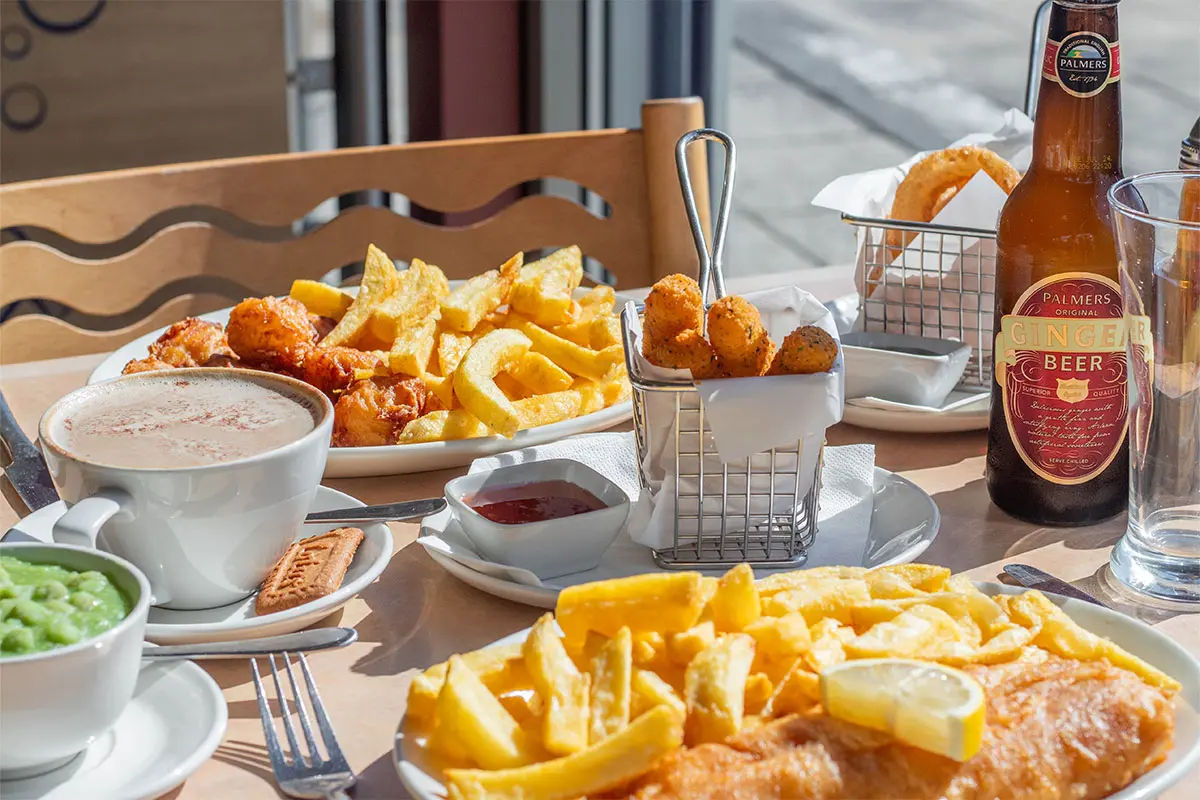 Various food served at Palmers Fish and Chips laid out on a table in the restaurant
